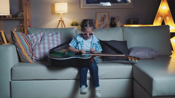 Little Girl Child Home In Room Playing Guitar And Having Fun alt