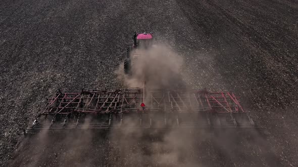 Tractor Cultivating Field. Agriculture and Machinery Aerial View