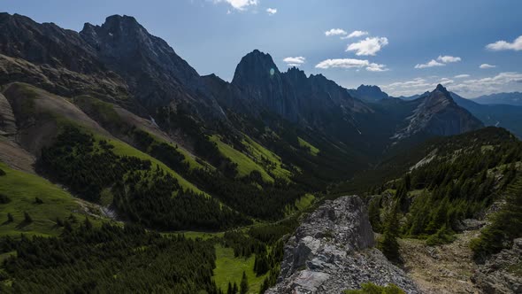 Vibrant Green Valley Between Towering Mountains  Time Lapse alt