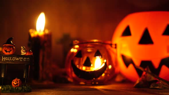 The concept of the Halloween festival with the orange pumpkin, candle light, and the bone skull