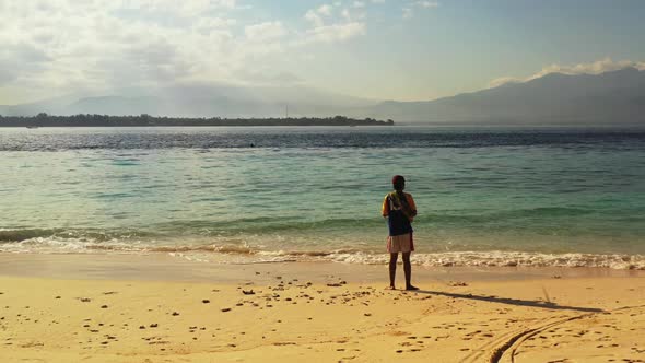 Guy catching fish on relaxing shore beach lifestyle by transparent sea and white sandy background of alt