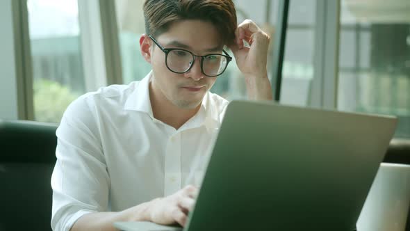 positive asian business male wearing glasses work remote new normal lifestyle