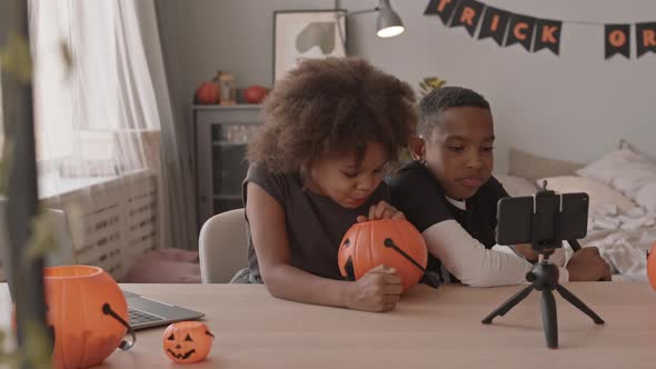 African American Siblings Eating Sweets on Halloween alt