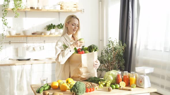 Happy Woman Takes Food Out of Her Bag She Bought a Lot of Fruits and Vegetables