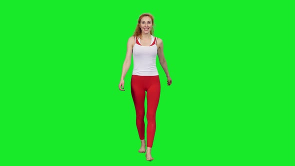 Smiling Slim Sporty Woman Walking and Waving Hand on Green Screen 