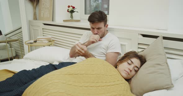Sick Man Laying Down Beside His Woman in a Modern alt