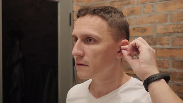 A Man Cleans His Ear with an Ear Stick