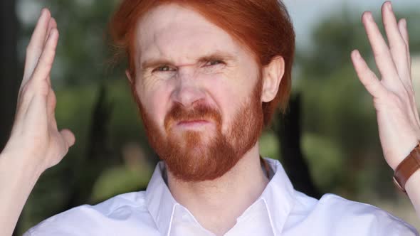 Young Man Upset by Loss while Working in Office alt