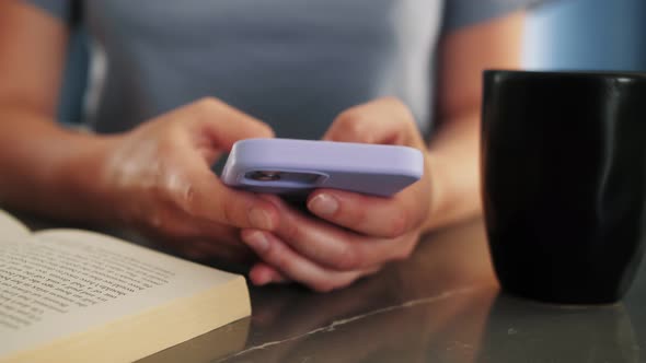 Hand of woman using mobile phone, chatting in social media in home morning. alt