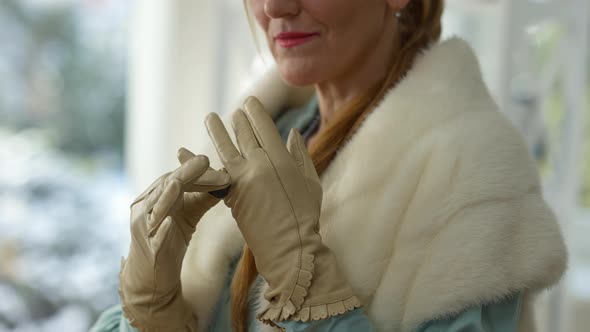 Unrecognizable Rich Elegant Middle Aged Woman Putting on Expensive Luxurious Ring on Glove Smiling alt