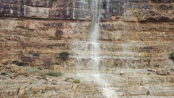 Israel, desert waterfall after rain, flood water, drone fly down shot alt
