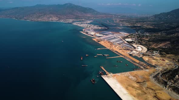 Massive Ca Na port under construction progress in Vietnam, high altitude drone view alt