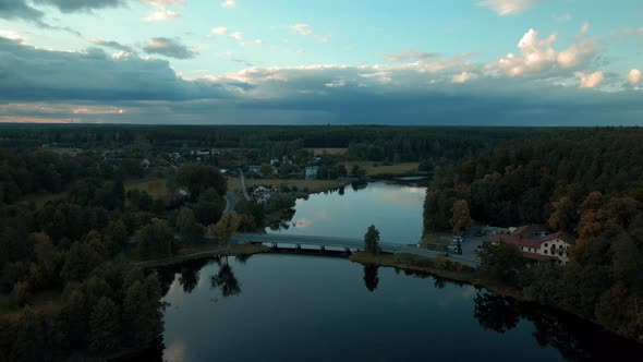 Phenomenal drone aerial of amazing Reflective River through small village of Kowalskie Blota alt