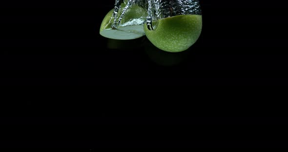 900447 Granny Smith Apples, malus domestica, Fruits entering Water against Black Background, Slow Mo alt