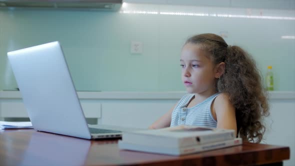 Little Girl a Cute Elementary School Child of 7-8 Years Old at Home Studying in Family Learning alt