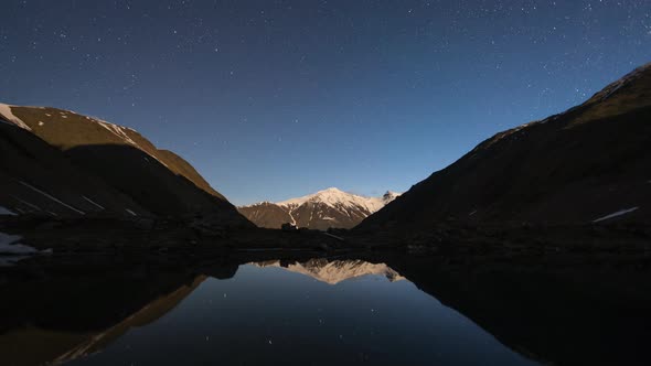 Starry Sky Night and Milky Way Time Lapse Over the Mountain Valley and a Lake