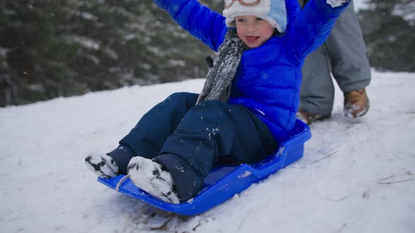 Carefree Childhood Happy Little Cute Boy Sledding in Winter Forest During Holidays Together with Mom