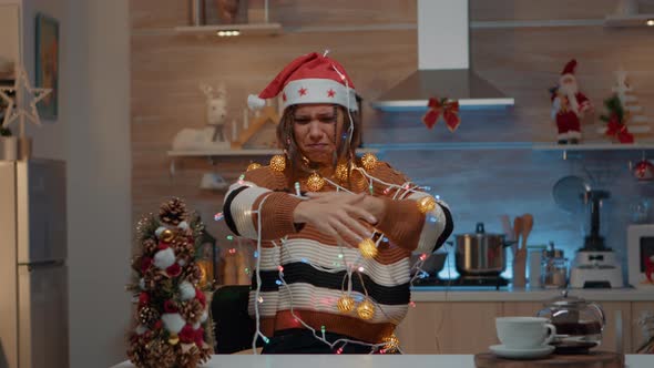 Woman Decorating Kitchen with Festive Ornaments alt
