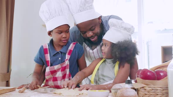 Active African American family in love having fun preparing lunch on a weekend