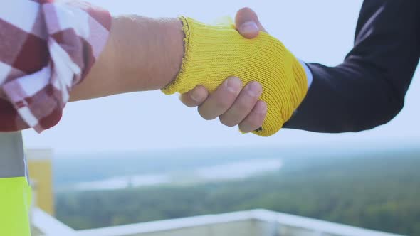 Contractor in Uniform and Gloves Shaking Hand Customer in Suit, Successful Deal