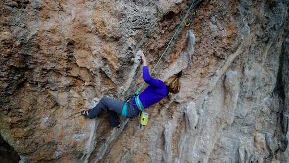 Strong Girl Rock Climber Climbs Rock Tufa on Overhanging Crag alt