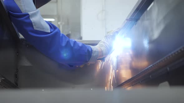Welder work welding torch sparks metal worker steel product. Craftsman iron worker welding metal box