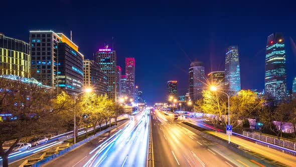Timelapse of busy traffic road with modern office building in beijing china alt