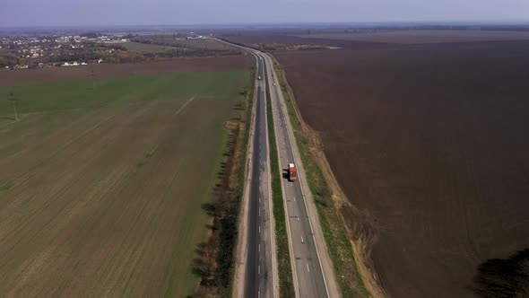Aerial View of a Beautiful Highway Along The Fields