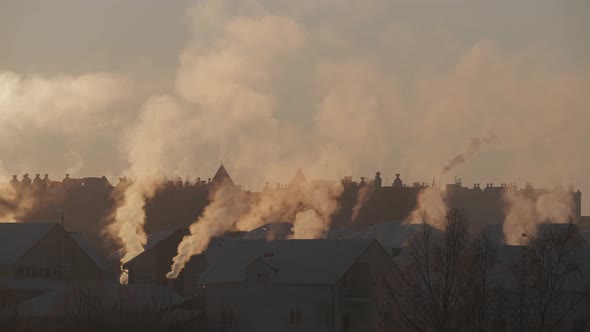 Early Morning in a Village with Smoke Rising From Pipes on Roofs of Houses