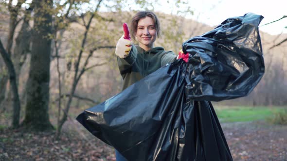 Portrait of a Beautiful Volunteer Woman with a Garbage Bag in Her Hands. Holding a Campaign To Clean