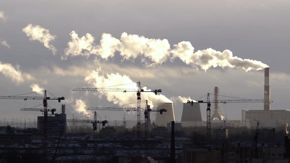 Smoke From the Pipes of the Power Plant Against the Background of Cranes. Industrial Area. The Smoke