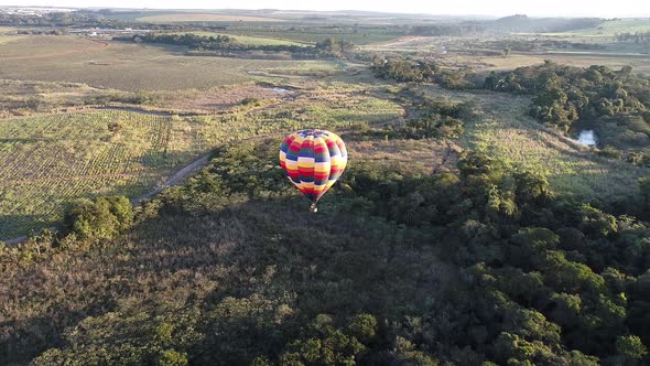 Colorful hot air balloon at countryside scenery. alt