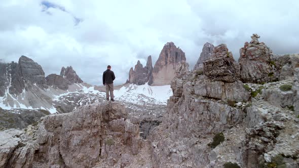 Aerial Man Hiker In Front of Tre Cime di Lavaredo Mountain in Dolomites Italy