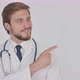 Young Doctor Pointing on Side on White Background - VideoHive Item for Sale