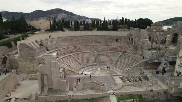 People visiting the Ruins of The Roman Theatre of Cartagena, ancient city landmark, Spain