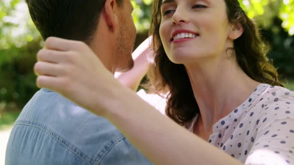 Romantic couple embracing each other in park alt