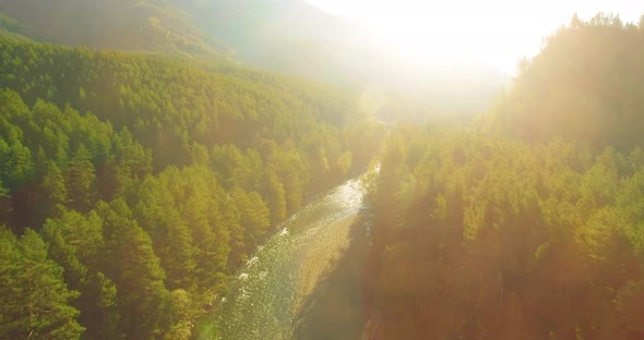 Low Altitude Flight Over Fresh Fast Mountain River with Rocks at Sunny Summer Morning. alt