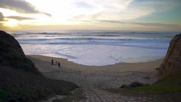 Beautiful sunset above the cliffs and people enjoying it. alt