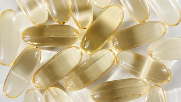 Macro Shot of a Yellow Oil Capsules Vitamin C Omega 3 Rotating Closeup alt