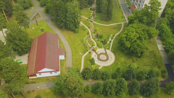 Newly Wedded Couple in Green Park with Stream Upper View alt