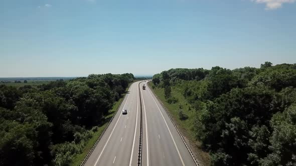  Aerial Shot of a Highway Passing Through the Rural Countryside and Green Forest alt