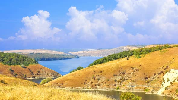 CINEMAGRAPH - The hills above the river, on a sunny day.