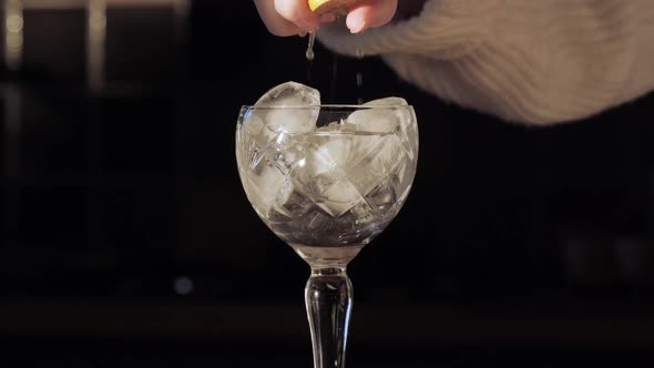 Crystal Glass Drink - Squeezing Lemon Juice In Cocktail alt