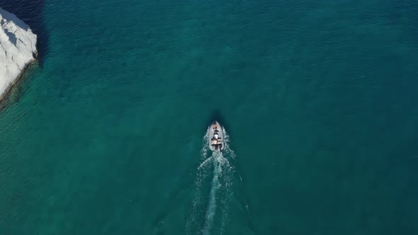 Overhead Top Down Birds Aerial View of Small Motor Boat on Crystal Clear Water alt