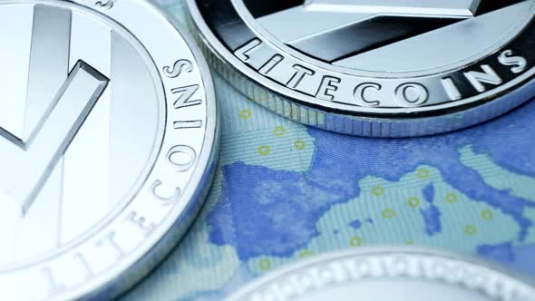 Silver Litecoin Coin on Euro Bills