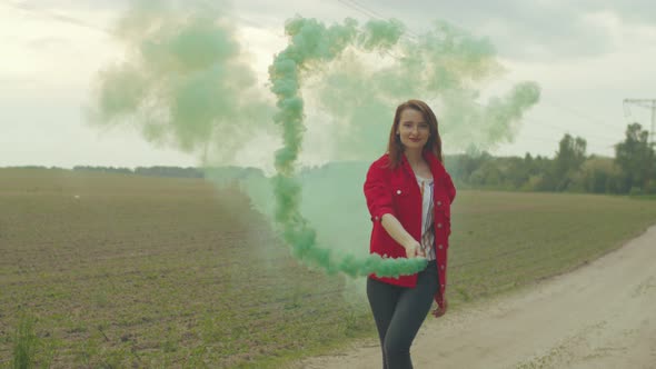 Woman Whirls in Color Smoke Walking on Rural Road alt