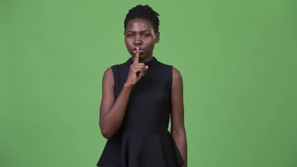 Young Beautiful African Businesswoman with Finger on Lips