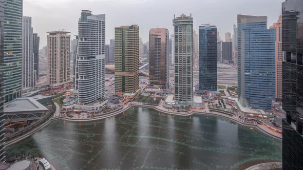 Residential and Office Buildings in Jumeirah Lake Towers District Day to Night Timelapse in Dubai alt