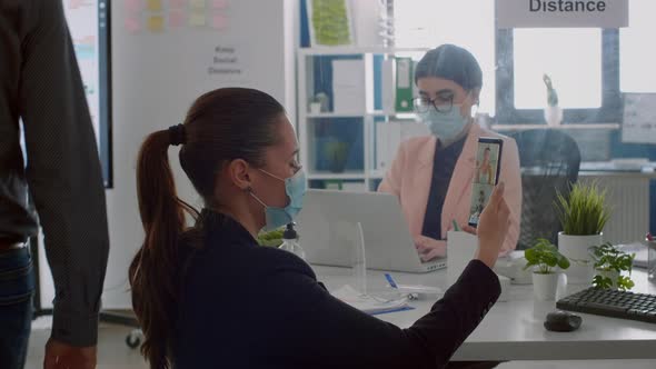 Businesswoman with Protection Medical Face Mask Talking on Webcam alt