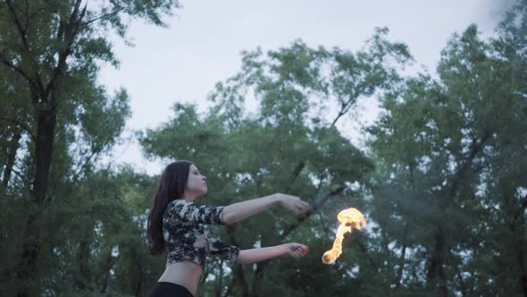 Portrait Cute Confident Woman Performing a Show with Flame Standing in the Forest or Park alt